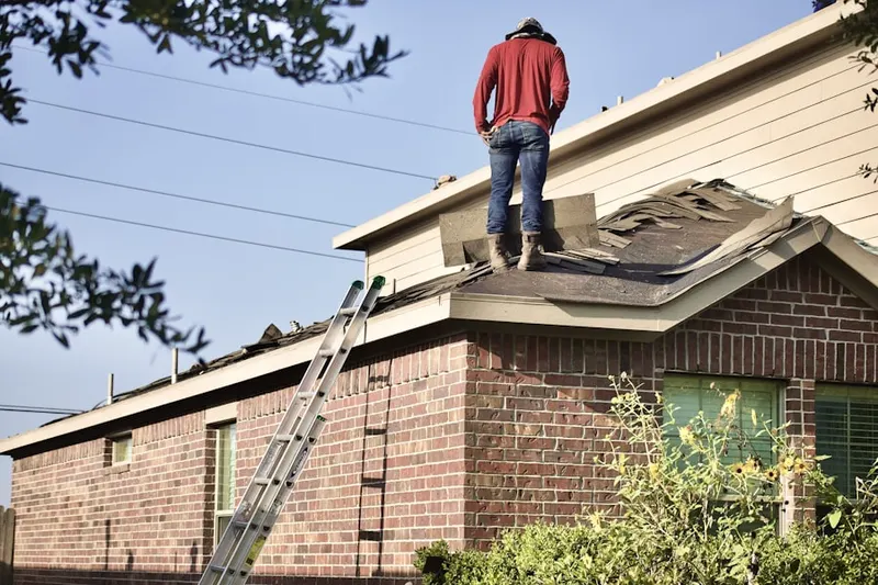 Professional roofer working on a residential roof in The Springs